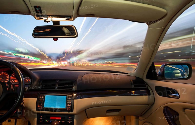 Car interior on driving. Blurred night lights