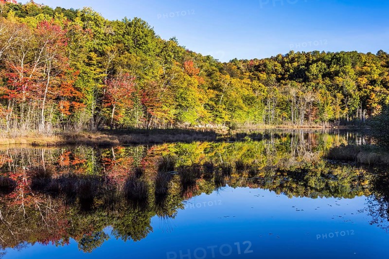 Magnificent resort in French Canada, the province of Quebec - Mont Tremblant. The water in the pond is smooth like a mirror. Concept of ecological and automobile tourism