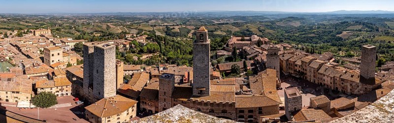 Wide panoramic view over downtown San Gimignano, Torri dei Salvucci and Torre Rognosa in the center, seen from Torre Grosso, Italy