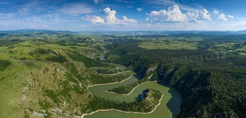 Aerial panorama of meanders at rocky river Uvac gorge on sunny day, southwest Serbia