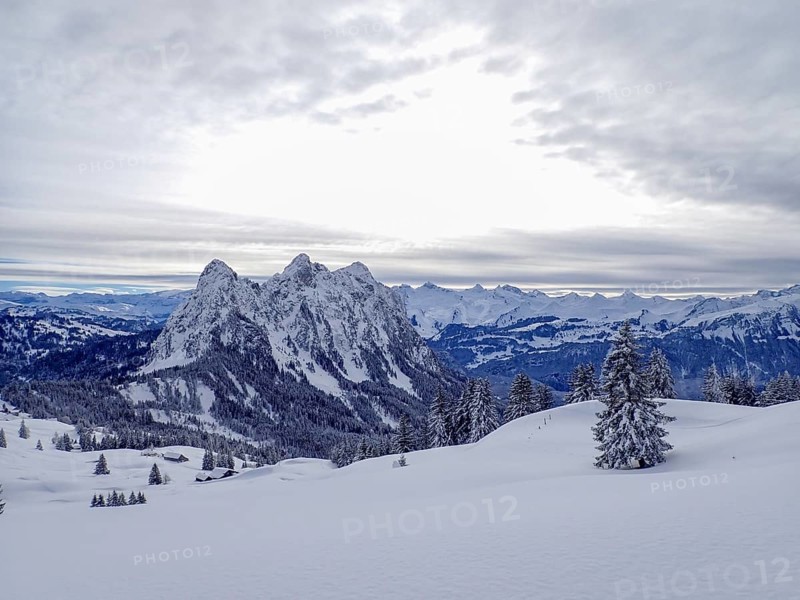 Beautiful winter landscape in central Switzerland. View towards the central Alps with the peaks of the Mythen massive