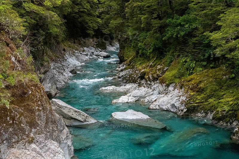 Colorful blue mountain river at the Haast pass, South Island of New Zealand