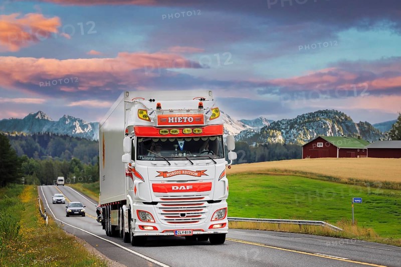 Beautifully customised DAF XF 530 semi trailer Kuljetusliike Jarmo Hieto Oy trucking along highway through beautiful landscape. 2019