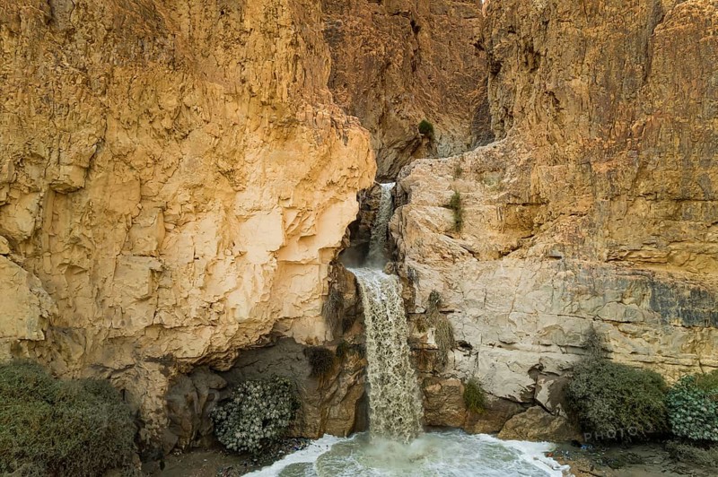 Unexpected powerful waterfall in the Judean Desert around the Dead Sea after heavy winter rains. This is one of the most famous deserts in the world. Shooting from a drone