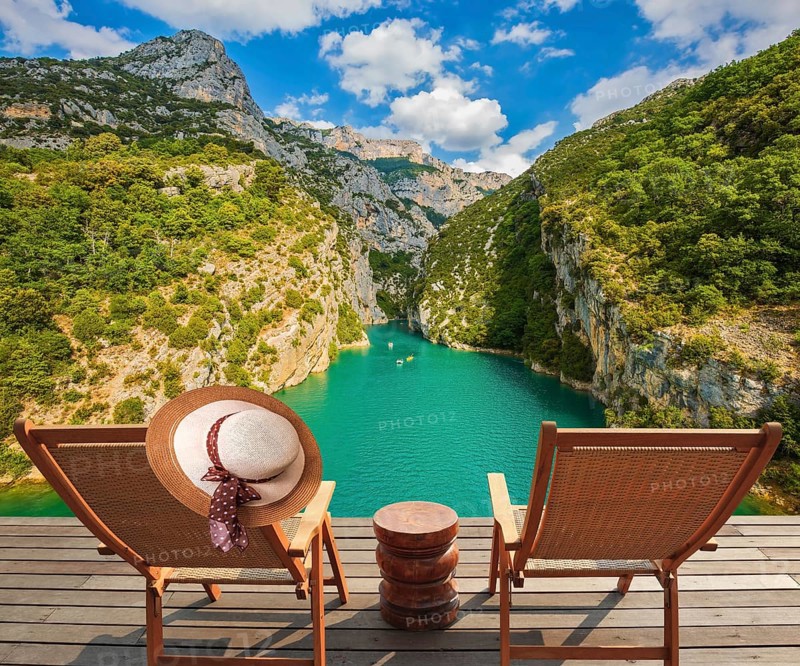 Travel across Provence. Two wooden chaise lounges on platform at the lake Verdon