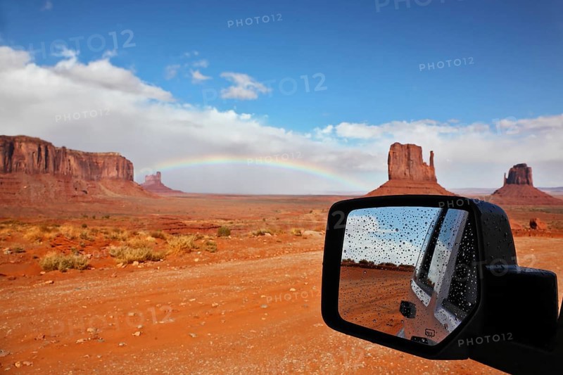 Monument Valley in the Navajo Indian Reservation. Arizona, USA. The unique red sandstone buttes are reflected in the car mirror