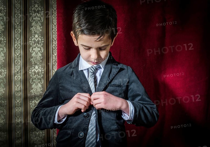 Boy in vintage black suit and tie