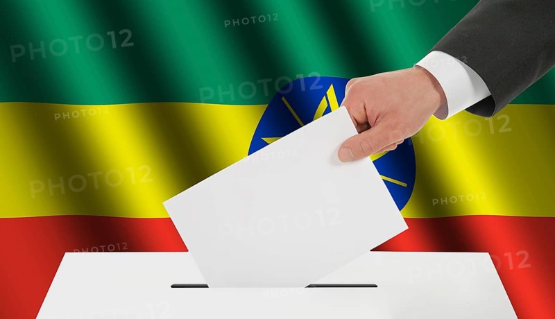 The Ethiopia flag and the hand with the bulletin about the ballot box