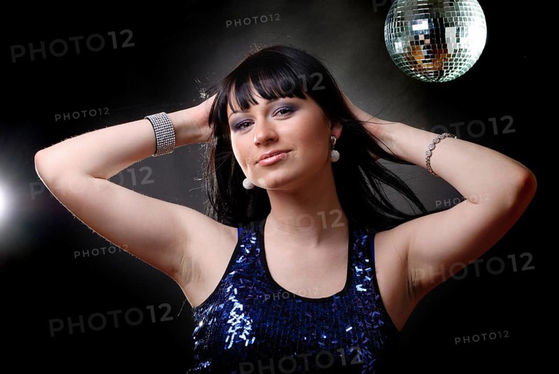 Girl in the nightclub is dancing in lights