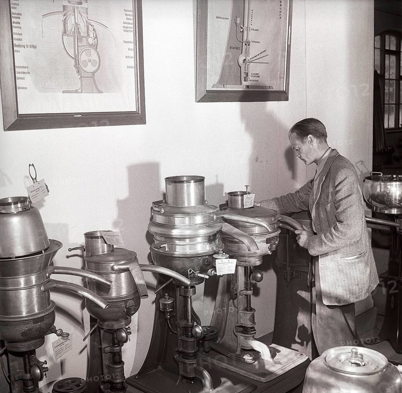 History of milk and cream making machinery. A man in a museum of separators. Machines made for the purpose of separating the cream and skim milk from fresh milk. By doing this it was possible to further process the cream into butter and cheese on a small scale. These separators were introduced in the late 1800s. Sweden 1953 ref BM26-4