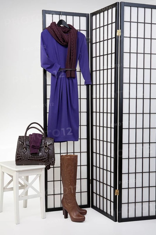 Woman's clothing and accessories on checkered folding screen