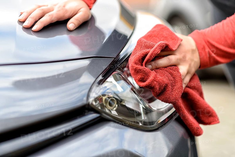 Polishing a car with a cloth after the car wash