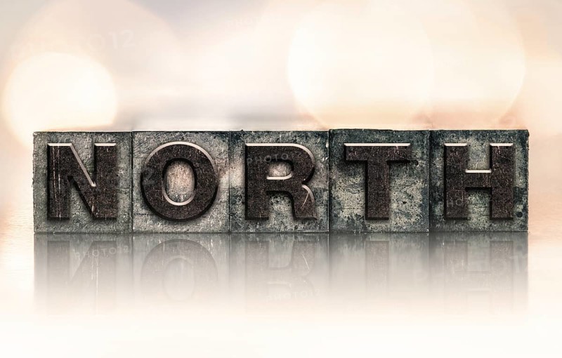 The word NORTH written in vintage ink stained letterpress type