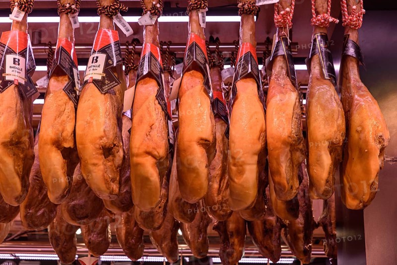 The stalls selling Jamón Serrano, the dry-cured Spanish ham made with Iberian pigs, in Barcelona, Spain