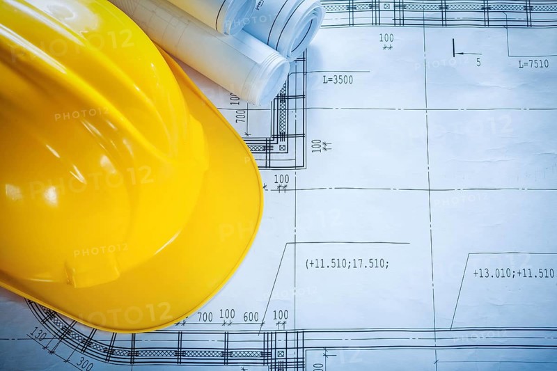 Protective building helmet construction drawings on blueprint