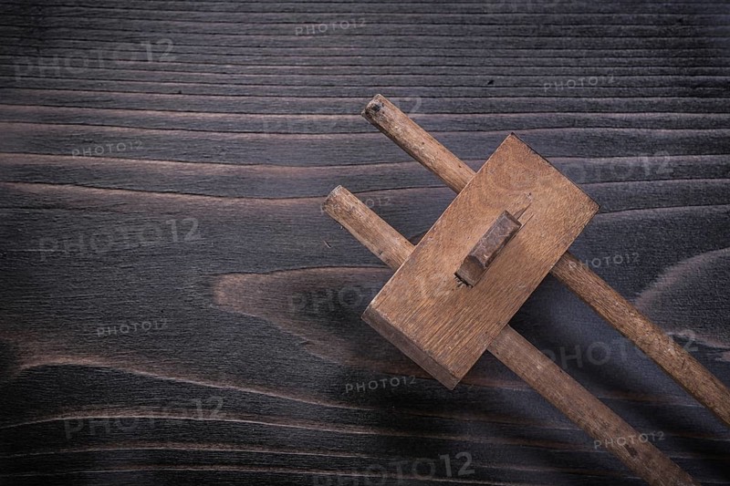 Vintage marking gage on wooden board construction concept