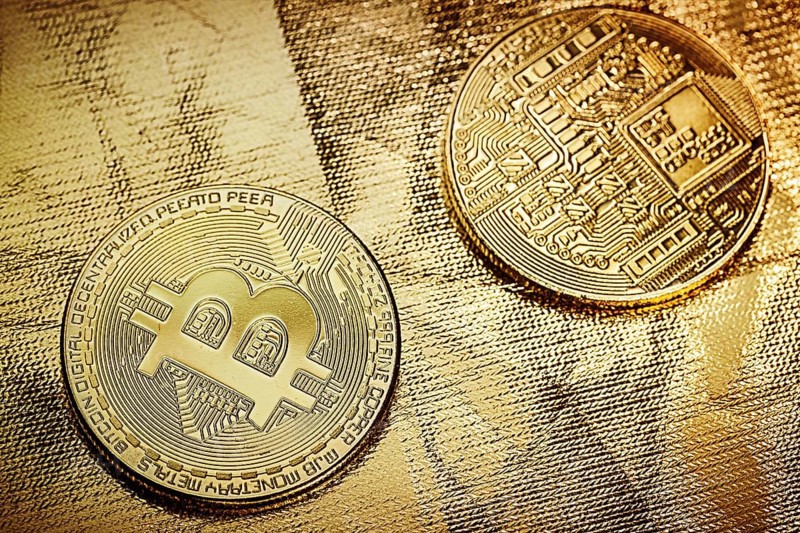 Two bitkoins on gold backgound