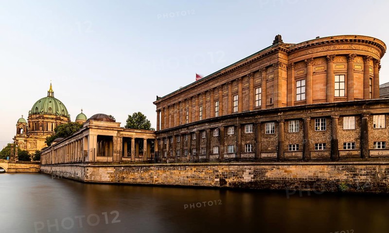 Scenic golden view of Spree river, Alte Nationalgalerie and Berlin Cathedral or Berliner Dom in Museum Island. Long exposure view at golden hour during sunset