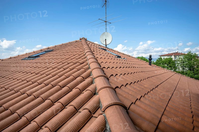 Red roof of the building against the blue sky. Copyspace for text, promotion or advertisement