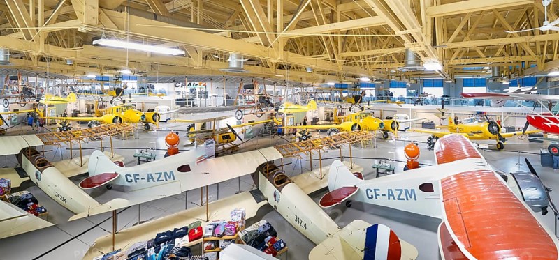 Calgary, Alberta, Canada. Aug 5, 2024. Several vintage aircraft on display in a the Hangar flight museum. The aircraft are of various sizes and colors, and some are suspended from the ceiling