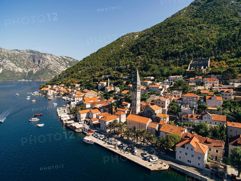 Drone view of the Perast coast with ancient houses and a tower. Montenegro.