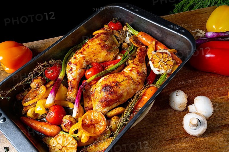 Roasted chicken legs with various vegetables