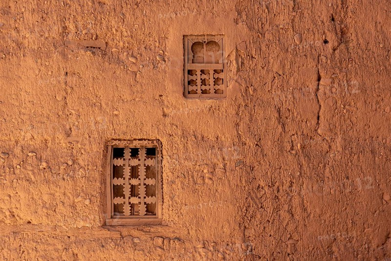 Two little windows in a typical berber house built of clay, Draa valley in Morocco
