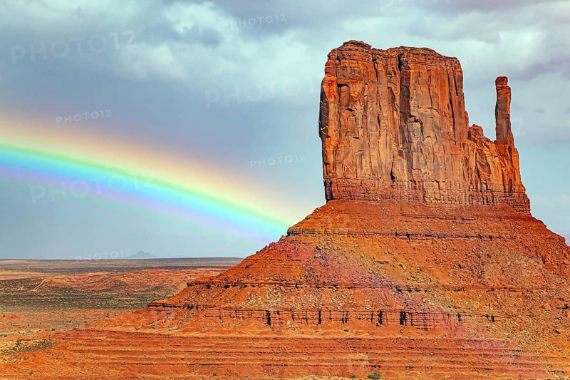 The famous rock Mittens and the bright rainbow. USA. Navajo Indian Reservations. Monument Valley is a unique geological formation in Arizona and Utah