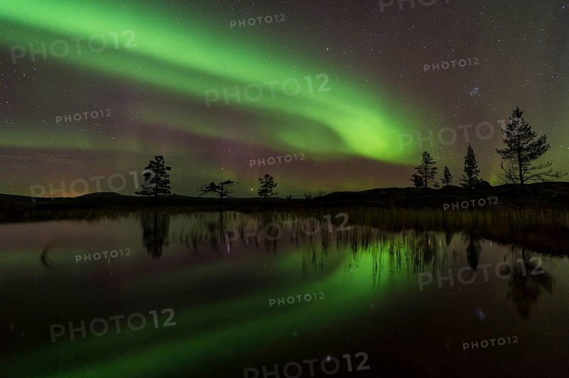 Northern Lights (Aurora borealis) reflected in a mountain lake, Gällivare, Norrbotten, Lapland, Sweden, October 2013