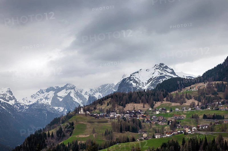 Alpine village in Dolomites mountains at cloudy day. Italian Dolomites
