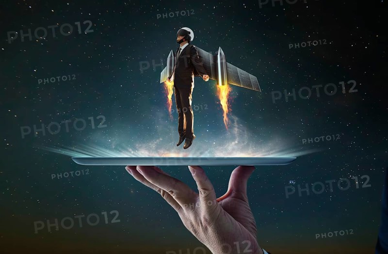 Waiter hand holding an empty digital tablet with Businessman wear a rocket suit to lift, Business success concept