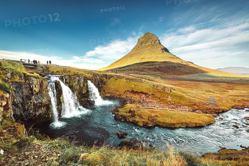 Landscape view of Kirkjufellsfoss In the daytime, blue sky and beautiful clouds. The waterfall is famous and a popular tourist spot in Iceland.