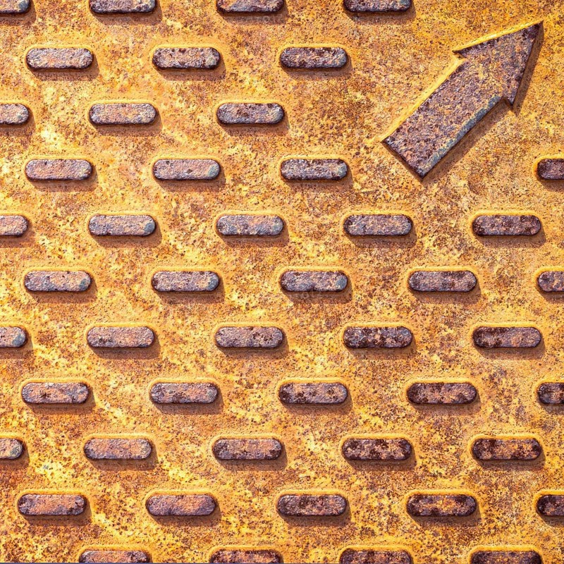 Steel rusty texture from Manhole cover. Orange metallic background
