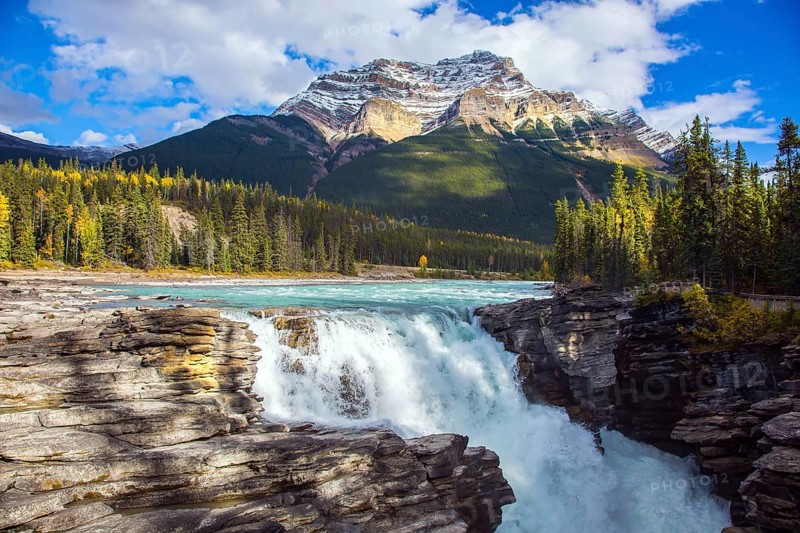 Athabasca Falls, popular with tourists. Rocky Mountains of Canada. The Athabasca River begins at the Columbia Glacier in Jasper Park. Travel, ecological and photo tourism concept