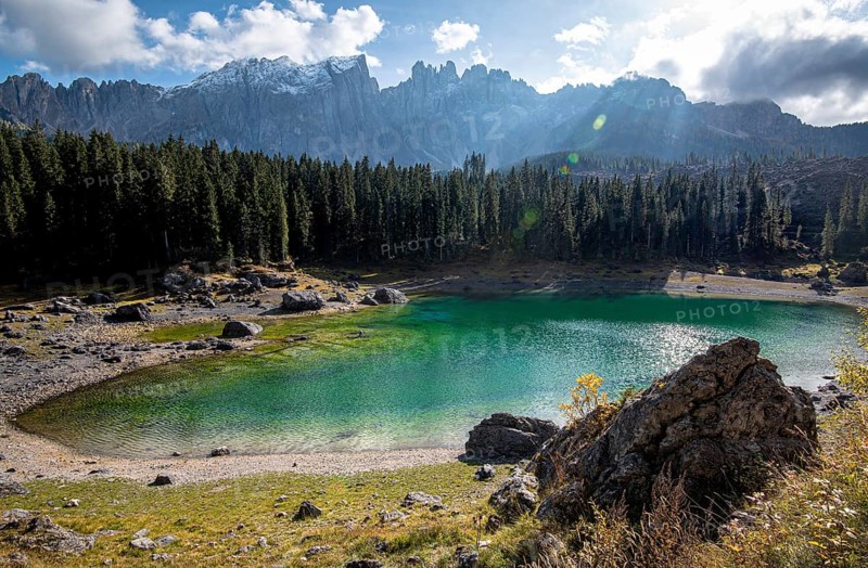 Lake Carezza or Karersee lake with deep blue colored water and the dolomite mountain range Trentino Alto Adige Region, Italy
