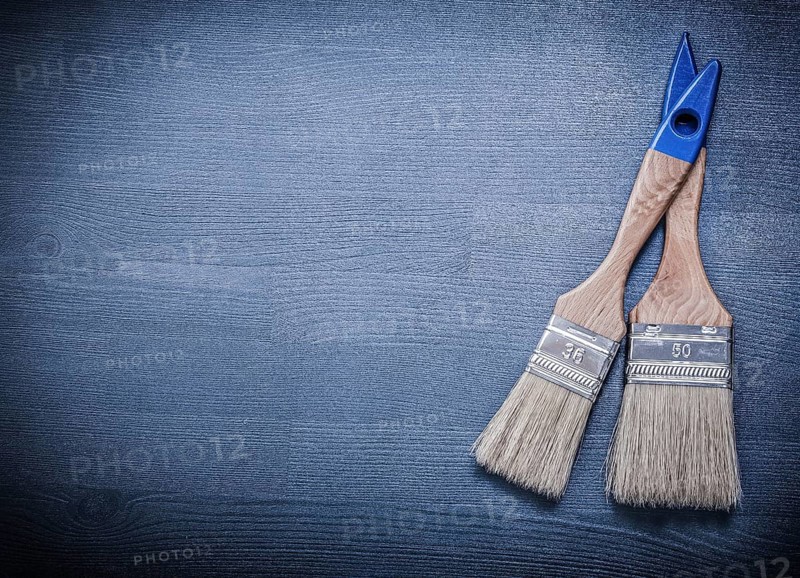 Paintbrushes on wooden board copy space construction concept