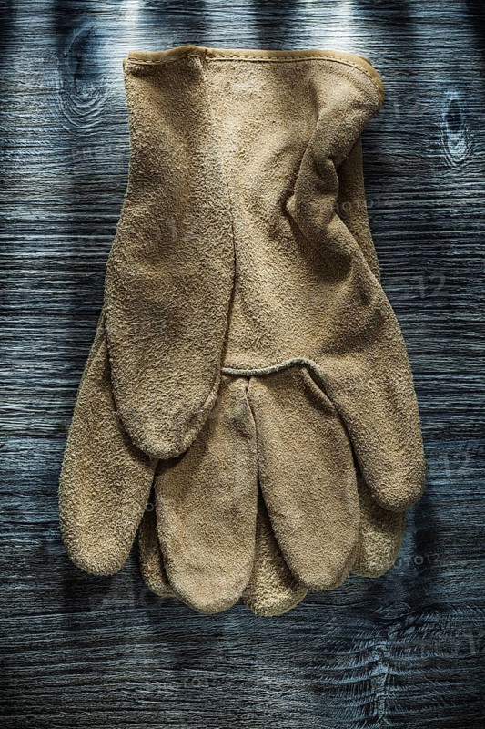 Safety gloves on wooden board