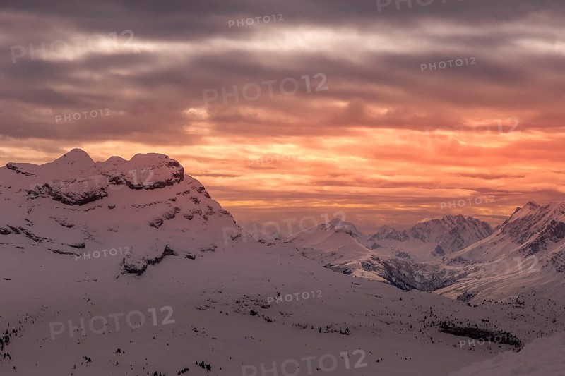 Colored sky at sunset sunset in snowy mountains. Flaine, Grand Massif, France, Arâches-la-Frasse, France