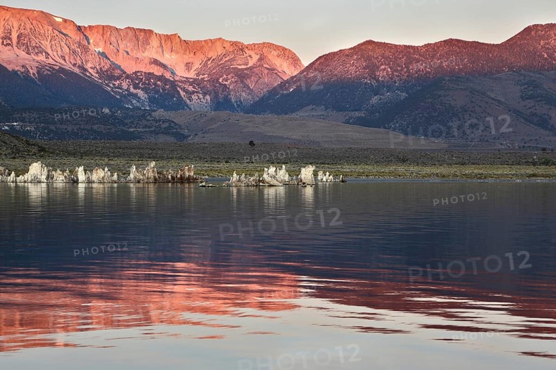 Sunrise at Mono Lake in the crater of an ancient extinct volcano. Shallow lake, a multitude of picturesque reefs Tufa. Magically beautiful sunrise