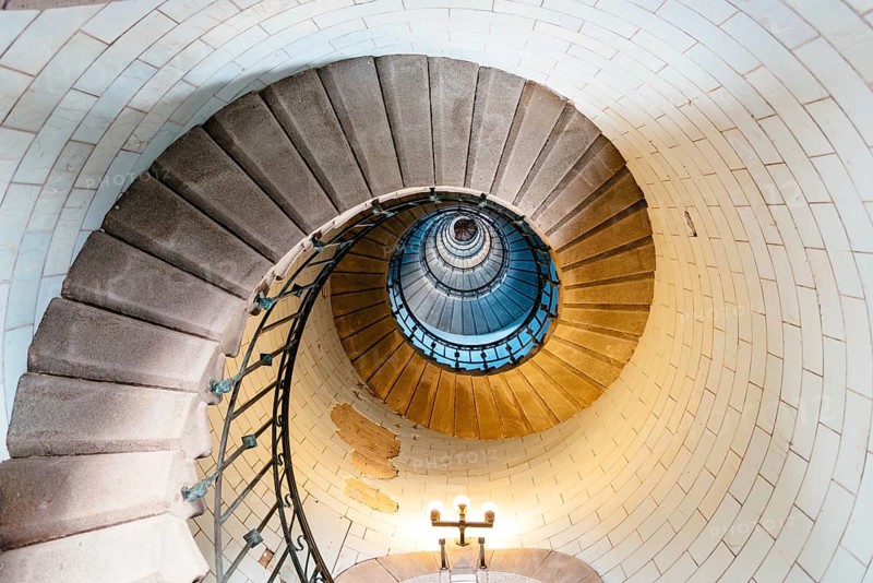 Penmarch, France, August 2, 2018: Spiral staircase in Eckmuhl Lighthouse in Brittany. Directly below view