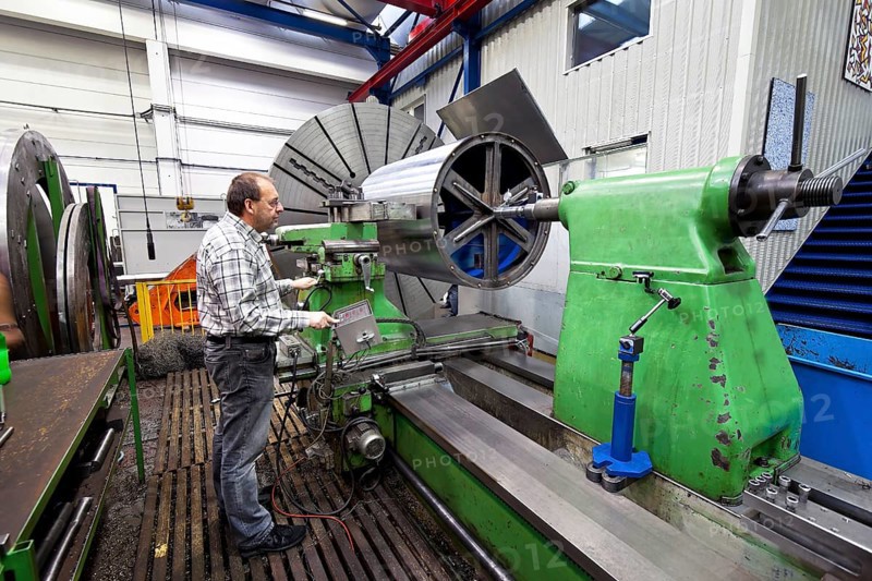 An older worker in the metal industry at a CNC milling machine, Austria