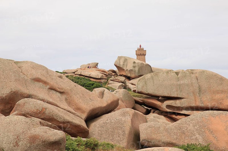 Granite boulder and lighthouse in Brittany, France