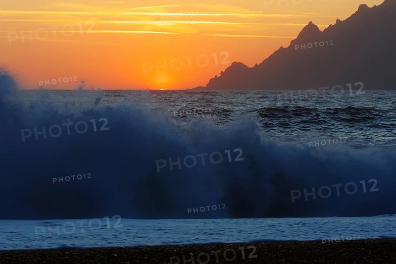 Surf wave at sunset on the beach in Porto, Corsica