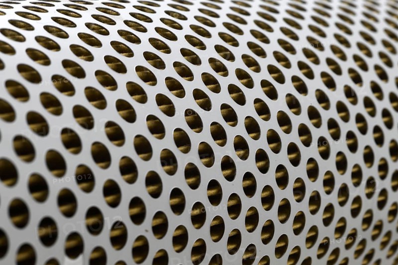 Detail of a tractor oil filter creates an industrial textured background