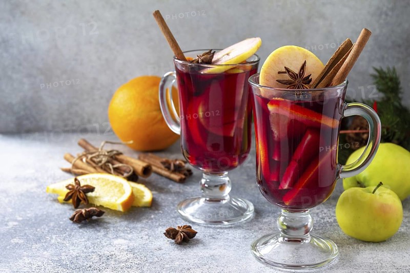 Christmas mulled wine, winter alcoholic drink. Two glass of mulled wine (gluhwein) and its ingredients on a stone background. Copy space