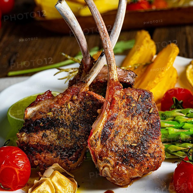 Lamb shanks marinated in herbs with green asparagus and lime
