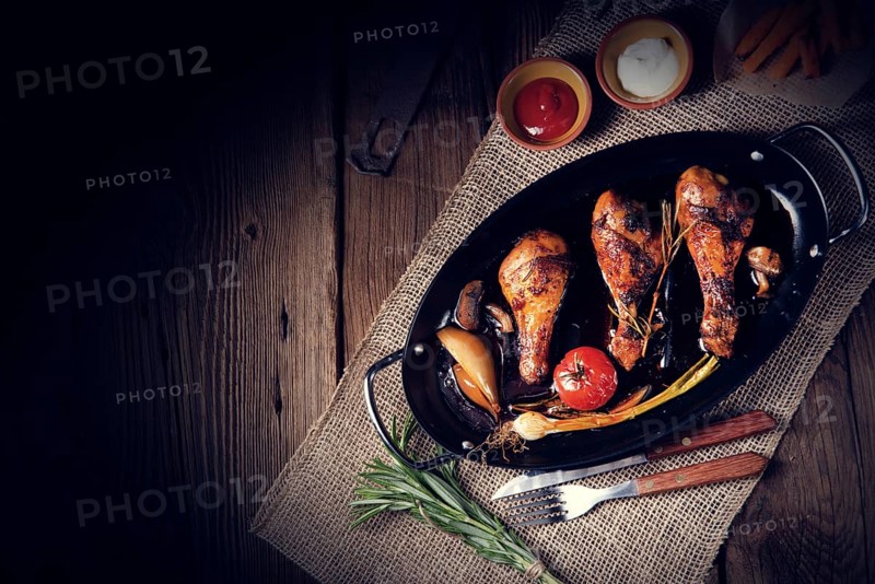 Grilled chicken legs in a barbecue marinade with sweet potatoes