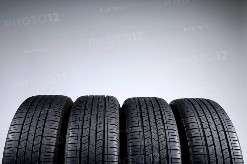 Set of all-season tires isolated on gray background