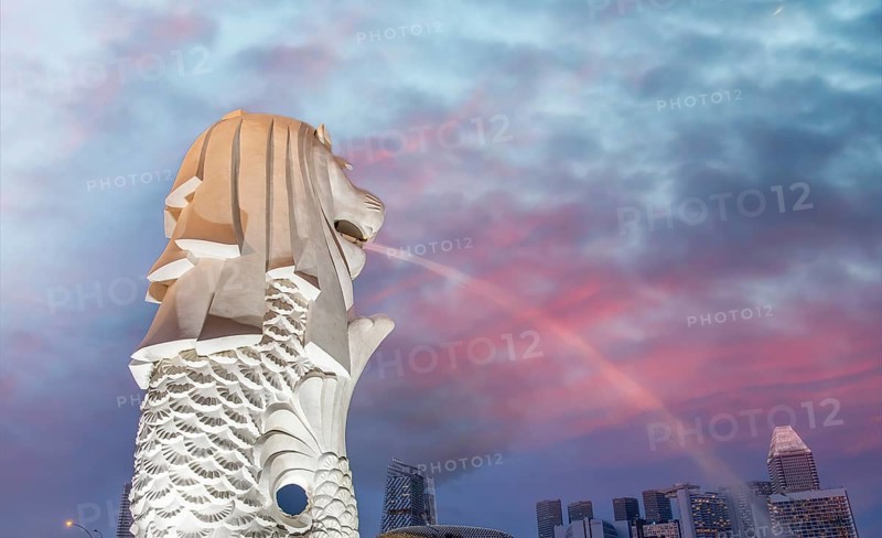 The Merlion of Singapore and the city skyline at sunset