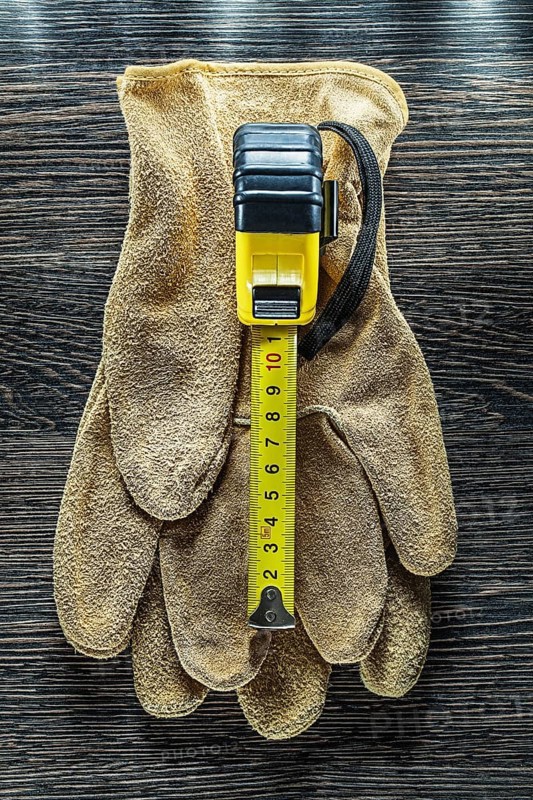 Tapeline safety gloves on wooden board